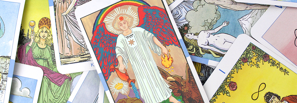 A collection of tarot cards scattered, featuring various vibrant illustrations, including an angelic figure with red wings and images of nature and celestial symbols.