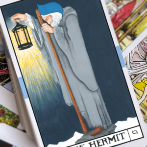 A tarot card depicting an elderly man in a cloak holding a lantern, standing alone in a snowy landscape. The card is titled "The Hermit.