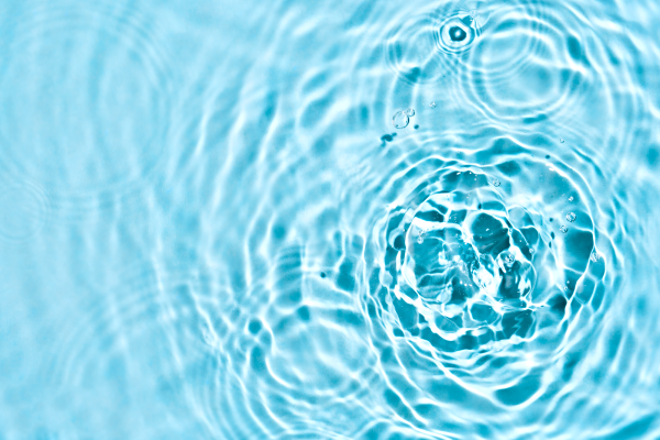Clear blue water with circular ripples spreading out from the center, where a drop has just fallen—each wave an expression of vibratory attunement, creating harmonious and overlapping patterns across the surface.